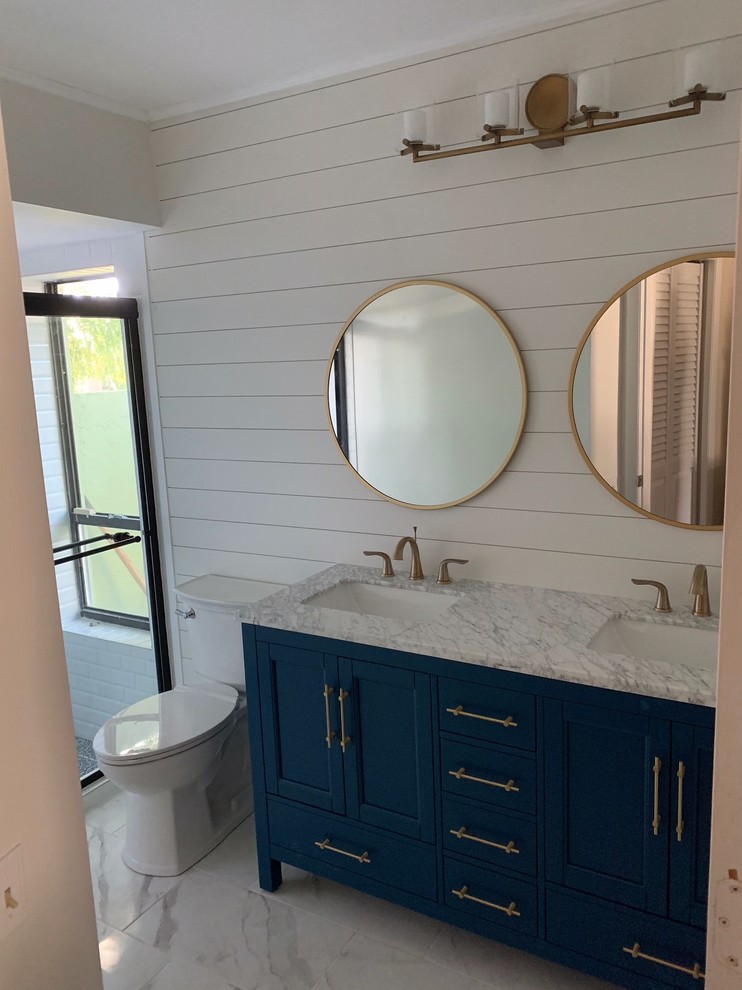 This is an example of a small traditional kids bathroom in Other with shaker cabinets, blue cabinets, an alcove shower, a one-piece toilet, white tile, subway tile, white walls, porcelain floors, an undermount sink, engineered quartz benchtops, white floor, a sliding shower screen and grey benchtops.