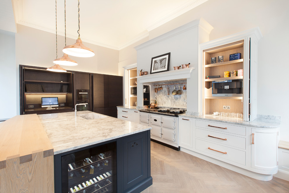 This is an example of a large contemporary open plan kitchen in Other with an integrated sink, shaker cabinets, white cabinets, quartz worktops, white splashback, stone slab splashback, integrated appliances, medium hardwood flooring and an island.