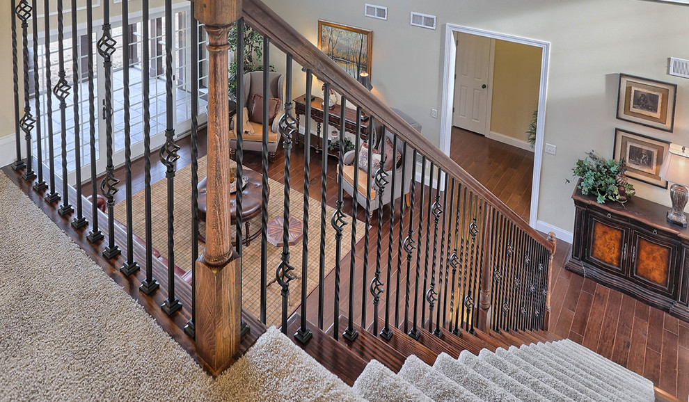 Photo of a large traditional wood straight staircase in Other with mixed railing.