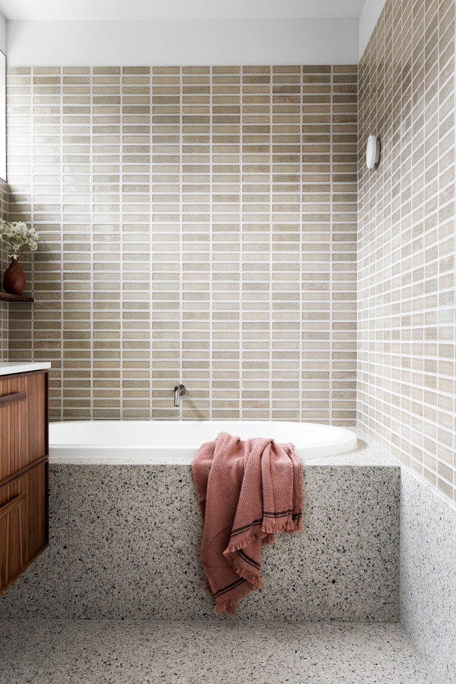 This is an example of a mid-sized contemporary bathroom in Melbourne with an open shower, subway tile and terrazzo floors.