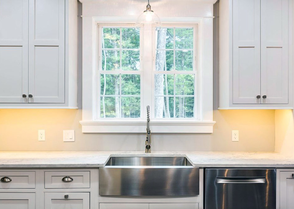 This is an example of a large traditional l-shaped eat-in kitchen in Other with a farmhouse sink, recessed-panel cabinets, white cabinets, stainless steel appliances, with island, white benchtop and quartz benchtops.