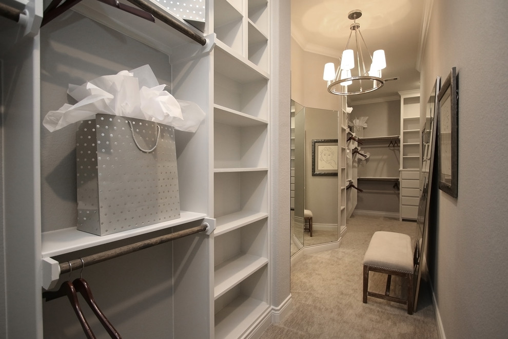 Design ideas for an expansive traditional gender-neutral dressing room in Houston with flat-panel cabinets, white cabinets, carpet and grey floor.