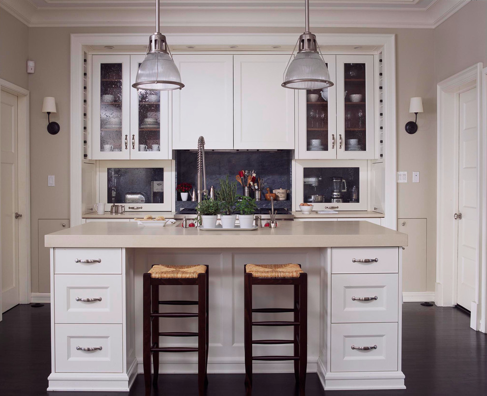 Photo of a traditional kitchen in Chicago with recessed-panel cabinets, white cabinets and black splashback.