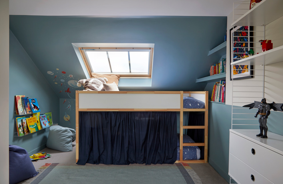 Inspiration for a small contemporary children’s room for boys in London with blue walls, carpet and beige floors.