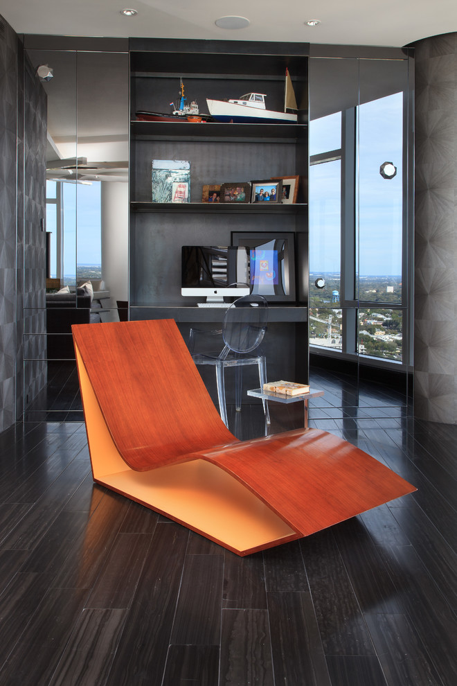This is an example of a contemporary home office in Tampa with grey walls and black floor.