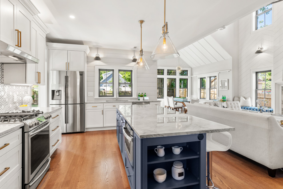 Country l-shaped kitchen in Boston with an undermount sink, shaker cabinets, marble benchtops, mosaic tile splashback, stainless steel appliances, with island, white cabinets, medium hardwood floors, brown floor, white benchtop and vaulted.