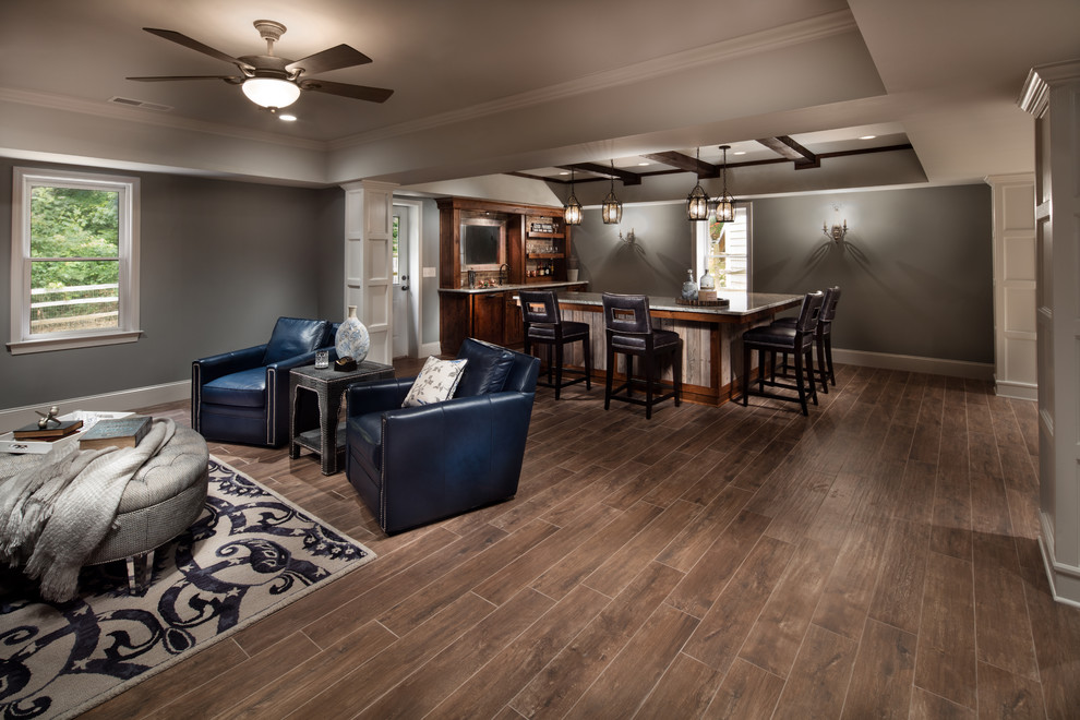 This is an example of a mid-sized transitional walk-out basement in Atlanta with grey walls and porcelain floors.