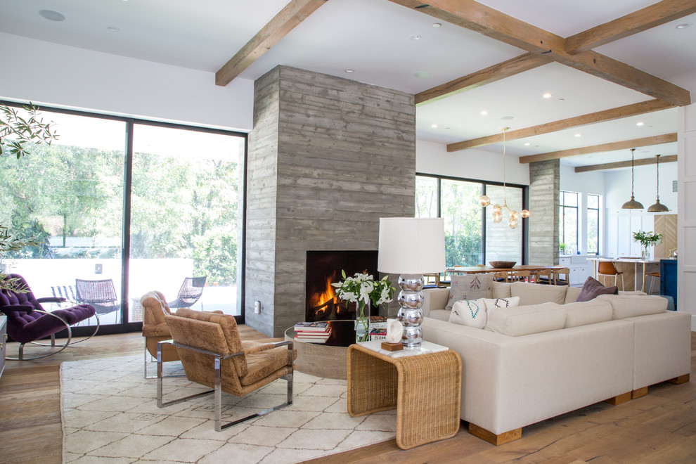 Design ideas for a large transitional formal open concept living room in Los Angeles with white walls, light hardwood floors, a standard fireplace, a concrete fireplace surround, no tv and beige floor.
