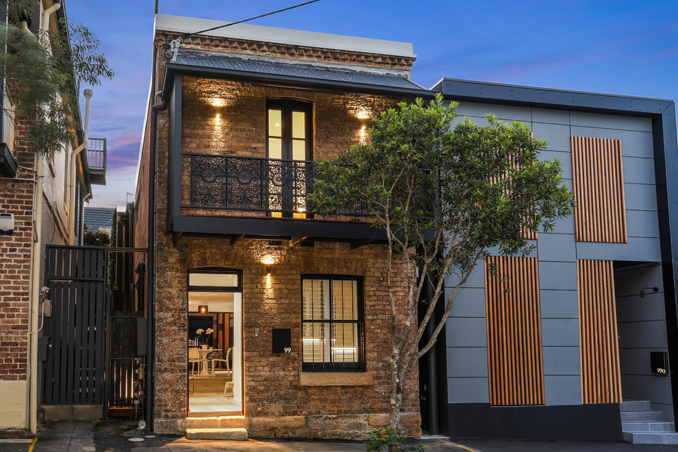 Inspiration for a small contemporary two-storey brick multi-coloured duplex exterior in Sydney with a flat roof and a metal roof.