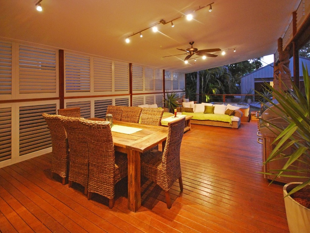 This is an example of a tropical backyard verandah in Dallas with decking and a roof extension.