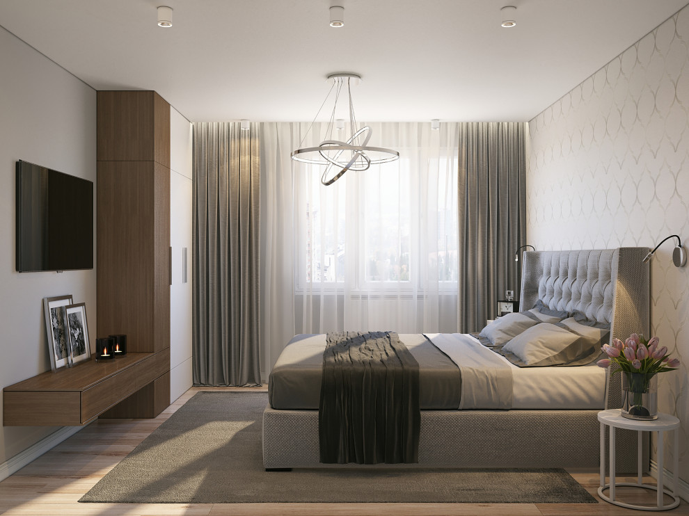 Ejemplo de dormitorio principal moderno de tamaño medio con paredes beige, suelo de madera clara, casetón y papel pintado