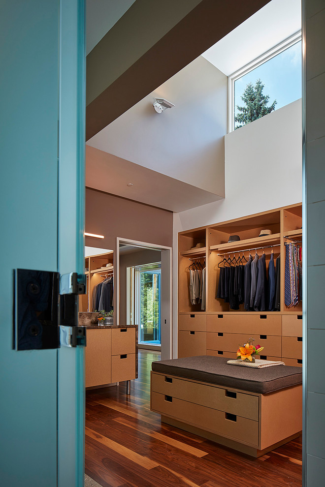 Large contemporary dressing room in Chicago with flat-panel cabinets, light wood cabinets and dark hardwood floors.
