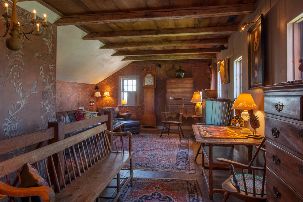 This is an example of a country loft-style family room in Boston with multi-coloured walls and dark hardwood floors.