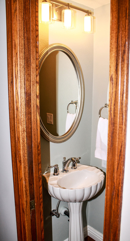Small transitional 3/4 medium tone wood floor and brown floor bathroom photo in Orange County with a one-piece toilet, green walls and a pedestal sink