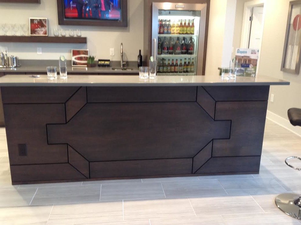 This is an example of a large traditional galley seated home bar in Other with an undermount sink, flat-panel cabinets, dark wood cabinets, granite benchtops, white splashback, porcelain floors and beige floor.