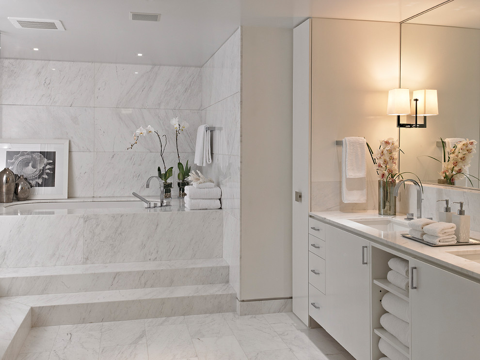 Inspiration for a contemporary bathroom in Miami with flat-panel cabinets, white cabinets, an undermount tub, white tile, white walls, an undermount sink and white floor.