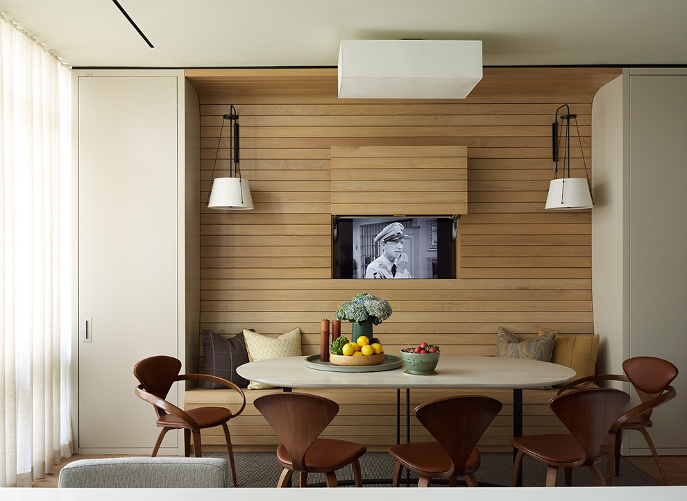 Inspiration for a contemporary dining room in New York with medium hardwood floors.