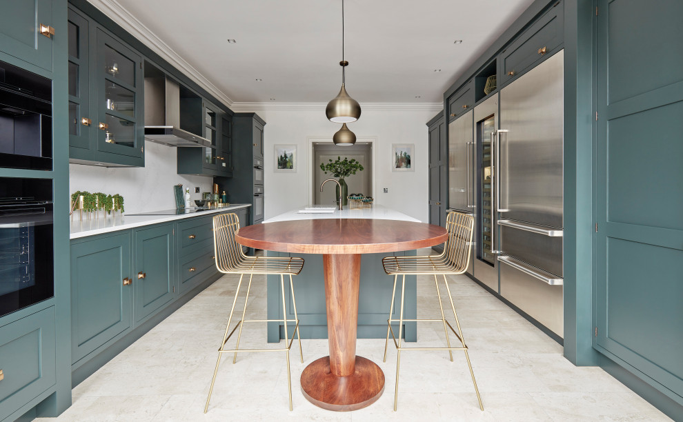 This is an example of a mid-sized transitional galley separate kitchen in Manchester with green cabinets, quartz benchtops, white splashback, engineered quartz splashback, stainless steel appliances, marble floors, with island, beige floor and white benchtop.