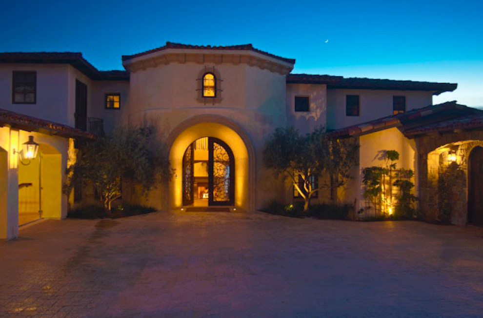 Photo of a large mediterranean two-storey stucco beige exterior in San Luis Obispo with a hip roof.