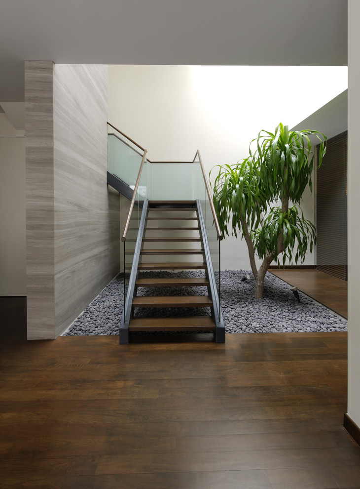 Design ideas for a mid-sized contemporary wood u-shaped staircase in Singapore with open risers.