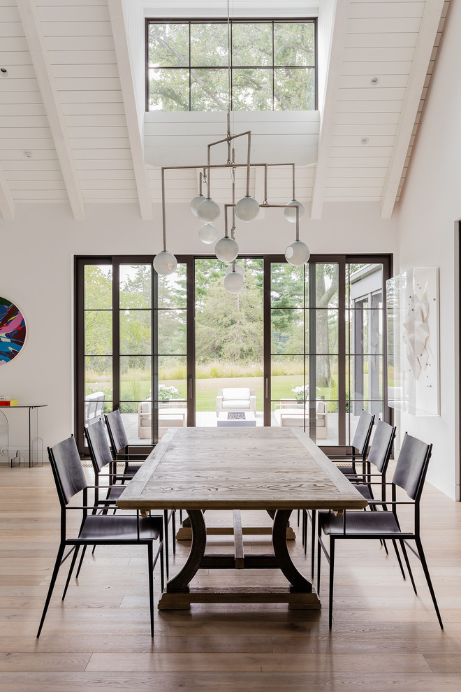 Example of a trendy beige floor great room design in Boston with white walls