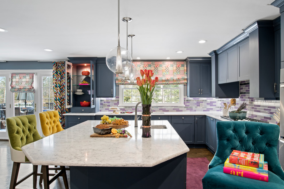 Inspiration for an expansive eclectic l-shaped eat-in kitchen in Philadelphia with a single-bowl sink, flat-panel cabinets, blue cabinets, marble benchtops, multi-coloured splashback, glass tile splashback, panelled appliances, dark hardwood floors, with island, brown floor and white benchtop.