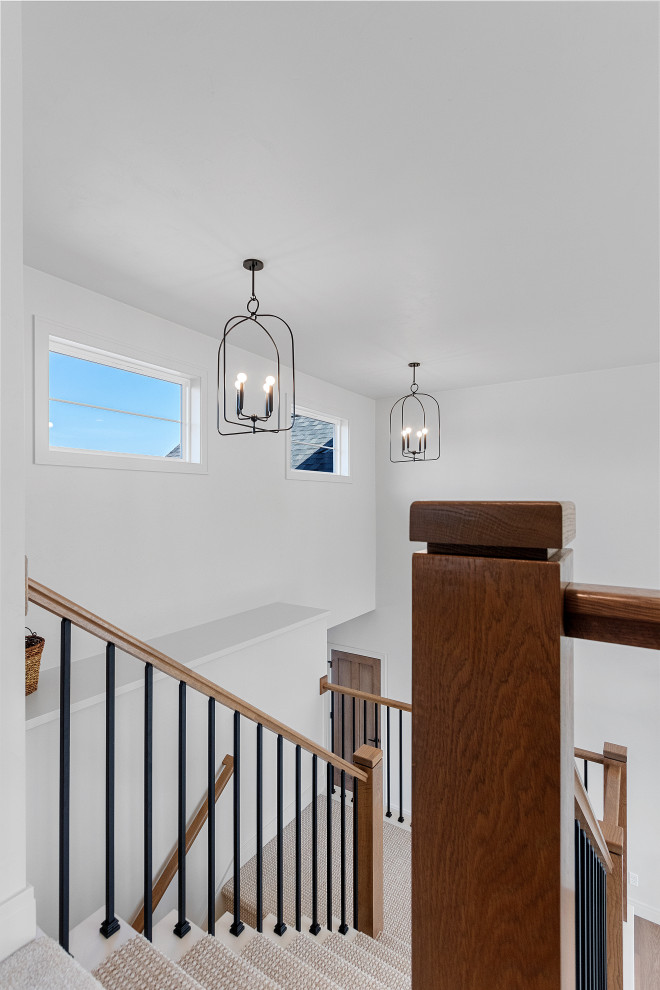 Example of a mid-sized transitional carpeted u-shaped mixed material railing staircase design with carpeted risers