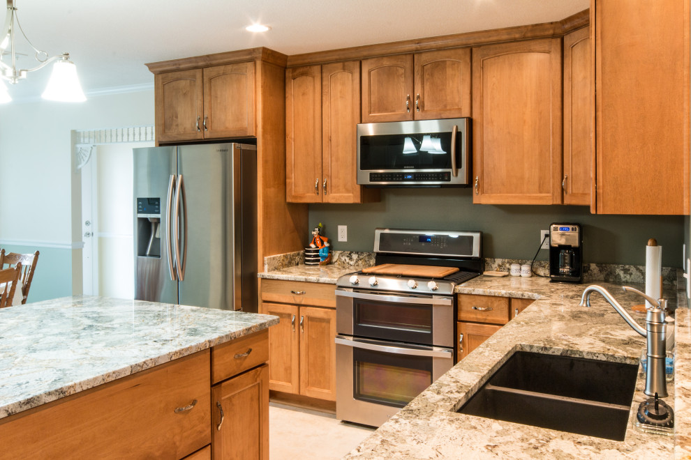 Eat-in kitchen - mid-sized l-shaped cement tile floor eat-in kitchen idea with an undermount sink, flat-panel cabinets, medium tone wood cabinets, granite countertops, stainless steel appliances and an island
