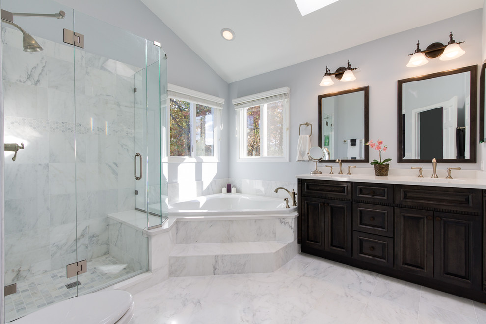 Corner bathtub - large transitional master white tile and marble tile marble floor corner bathtub idea in Chicago with dark wood cabinets, a one-piece toilet, gray walls, an undermount sink, marble countertops and beaded inset cabinets