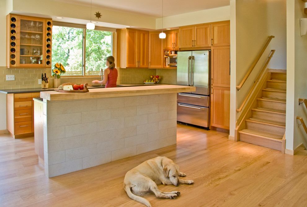 Transitional single-wall open concept kitchen photo in Denver with an undermount sink, recessed-panel cabinets, medium tone wood cabinets, wood countertops, yellow backsplash and stainless steel appliances