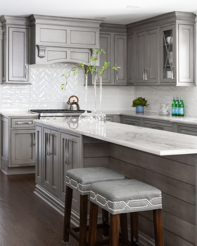 Large trendy galley dark wood floor and brown floor eat-in kitchen photo in Newark with an undermount sink, beaded inset cabinets, gray cabinets, quartzite countertops, white backsplash, ceramic backsplash, paneled appliances, two islands and gray countertops