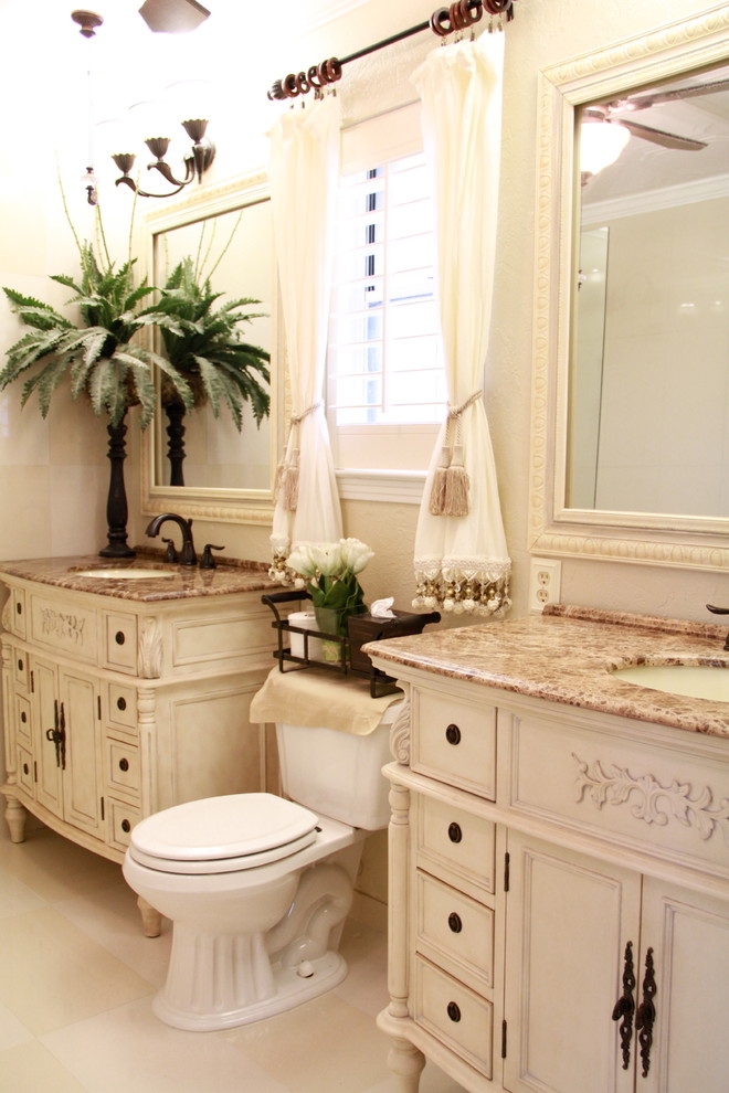 Mid-sized transitional master bathroom in New Orleans with beige cabinets, marble benchtops, white tile, an integrated sink, a shower/bathtub combo, a one-piece toilet, beige walls, marble floors and recessed-panel cabinets.