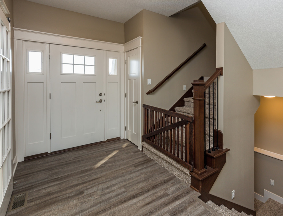 Front door - transitional vinyl floor front door idea with beige walls and a white front door