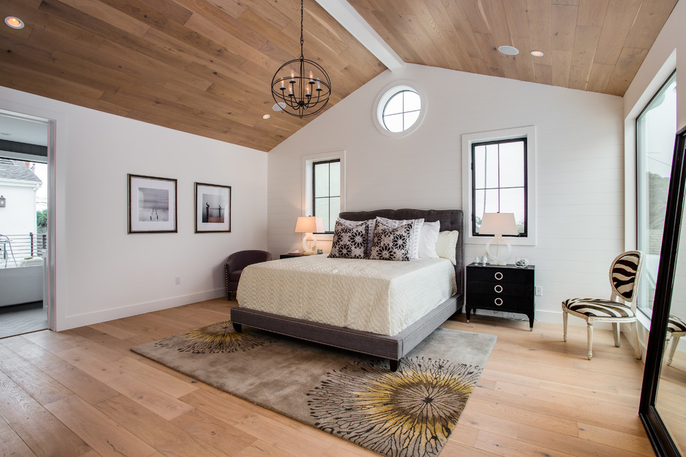 Design ideas for a transitional bedroom in Los Angeles with light hardwood floors and white walls.