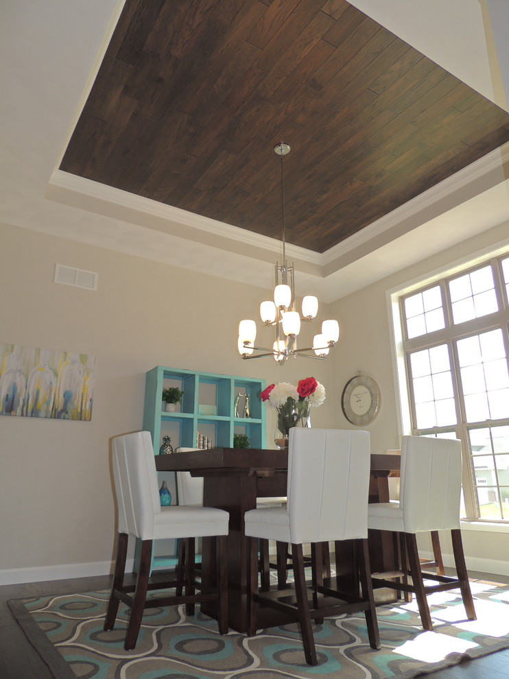 Design ideas for a mid-sized traditional separate dining room in St Louis with beige walls and medium hardwood floors.
