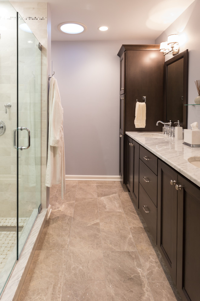 Design ideas for a large transitional master bathroom in New York with an undermount sink, shaker cabinets, marble benchtops, an alcove shower, a two-piece toilet, white tile, stone tile, blue walls, marble floors and dark wood cabinets.