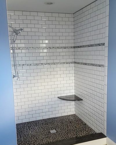 Mid-sized transitional 3/4 white tile and subway tile pebble tile floor and brown floor corner shower photo with blue walls