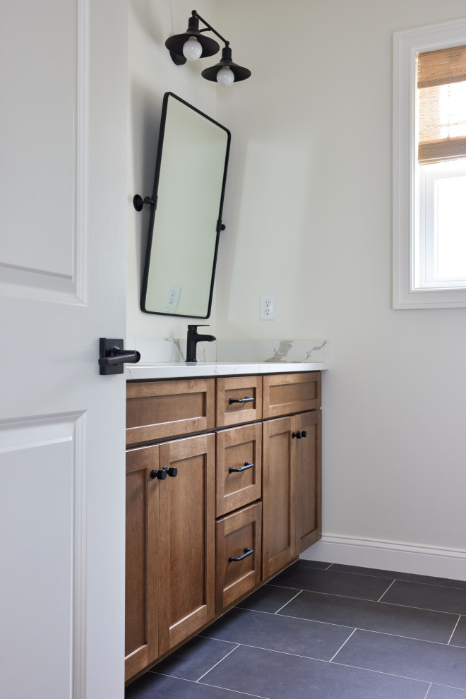 Example of a mid-sized arts and crafts master ceramic tile, gray floor and double-sink bathroom design in Boston with recessed-panel cabinets, medium tone wood cabinets, an undermount sink, quartz countertops, white countertops and a built-in vanity