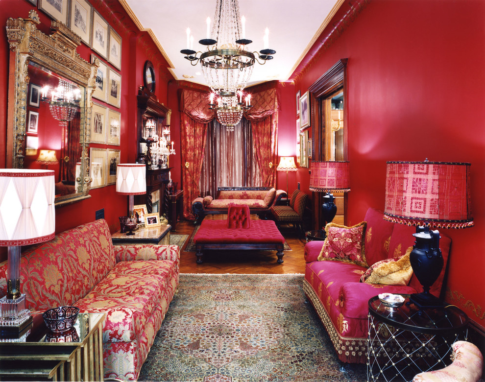 This is an example of a mid-sized traditional formal enclosed living room in New York with red walls, medium hardwood floors, a standard fireplace, no tv and brown floor.