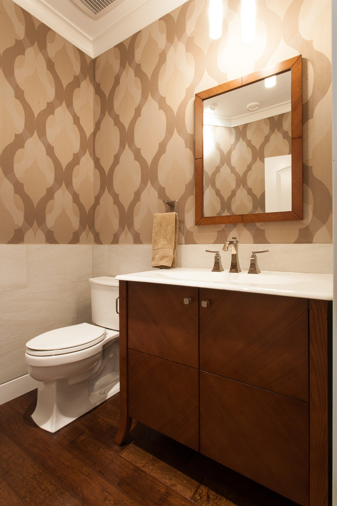 Photo of a transitional powder room in Vancouver with flat-panel cabinets, dark wood cabinets and beige tile.