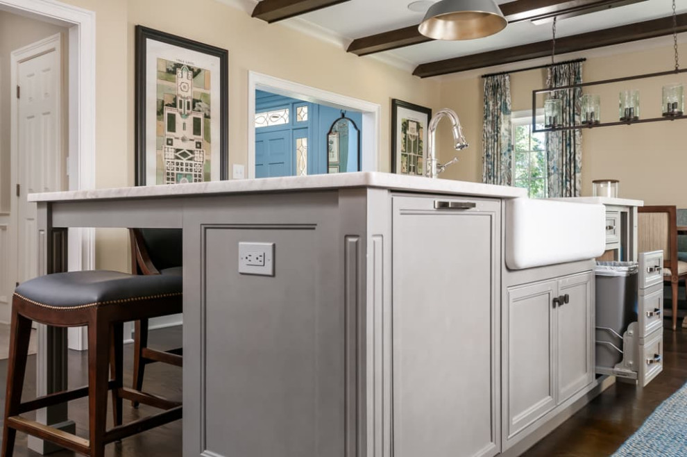 Large country eat-in kitchen in Atlanta with a farmhouse sink, recessed-panel cabinets, white cabinets, granite benchtops, grey splashback, cement tile splashback, stainless steel appliances, dark hardwood floors, multiple islands, brown floor and white benchtop.