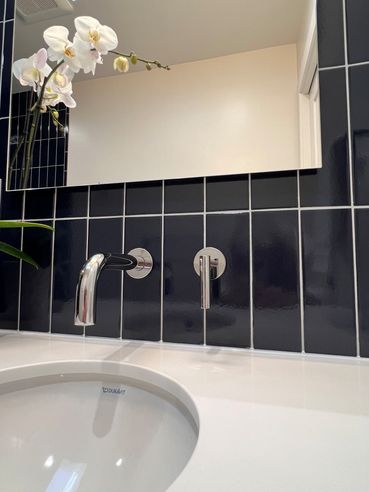 Trendy ceramic tile and white floor powder room photo in Sacramento with flat-panel cabinets, white cabinets, quartz countertops, white countertops and a floating vanity