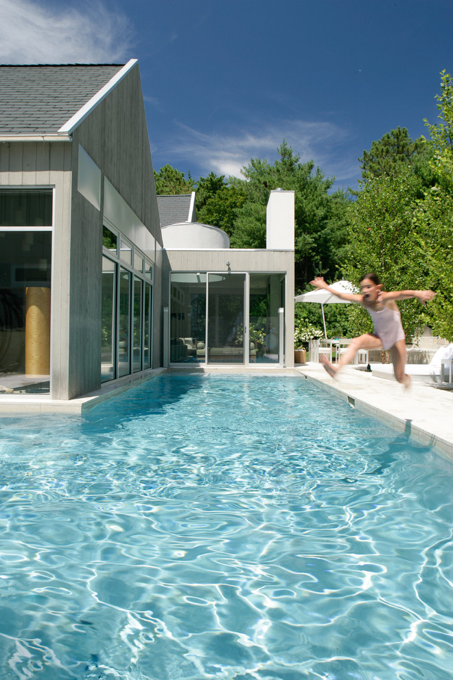 Inspiration for a mid-sized country backyard custom-shaped lap pool in New York.