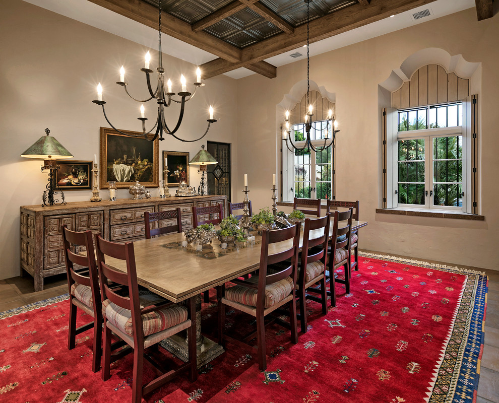 This is an example of a mediterranean separate dining room in Santa Barbara with beige walls and terra-cotta floors.