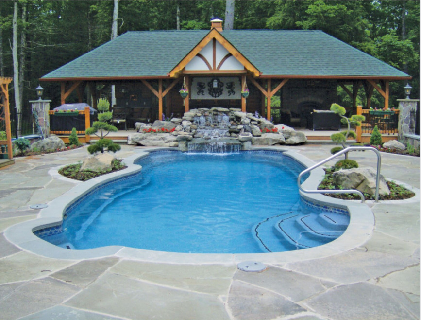 Design ideas for a mid-sized asian backyard custom-shaped pool in New York with natural stone pavers.