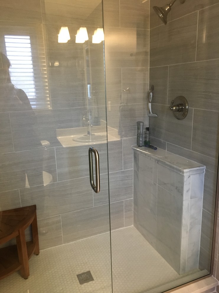Small transitional master bathroom in Indianapolis with flat-panel cabinets, white cabinets, an alcove shower, a one-piece toilet, gray tile, ceramic tile, blue walls, ceramic floors, a drop-in sink, solid surface benchtops, grey floor and a hinged shower door.