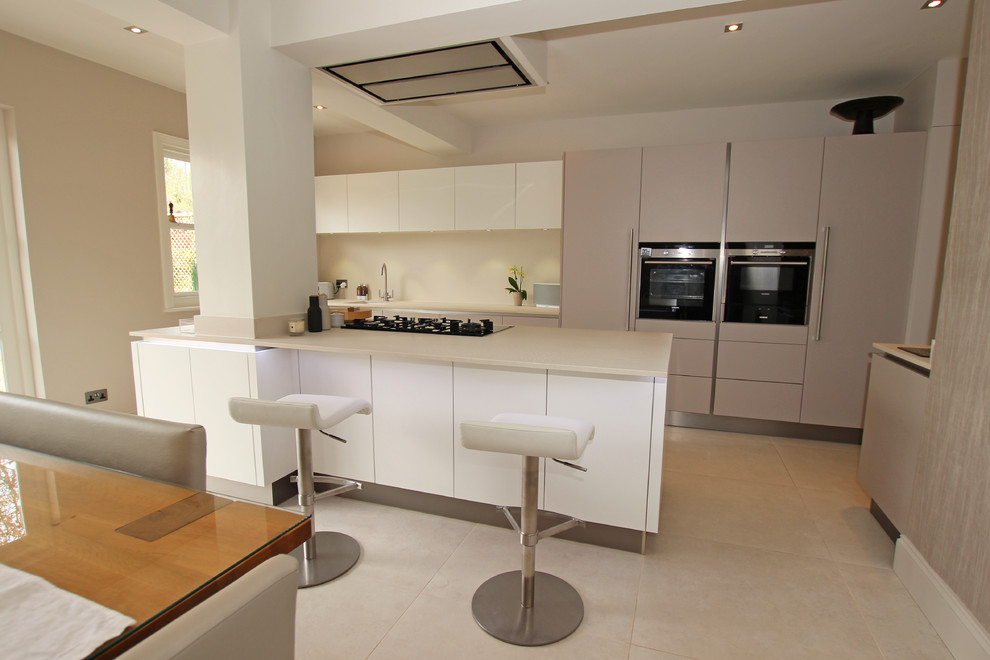 Inspiration for a modern kitchen in London with flat-panel cabinets, quartz benchtops and with island.