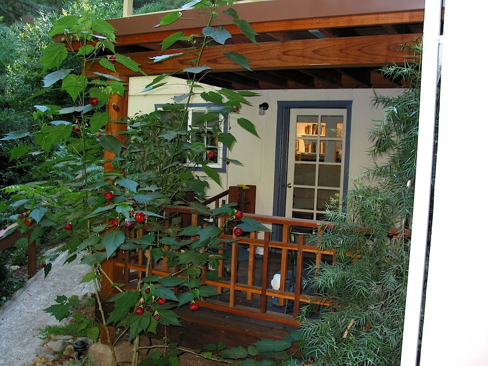 Design ideas for a small asian backyard deck in Other with a roof extension.