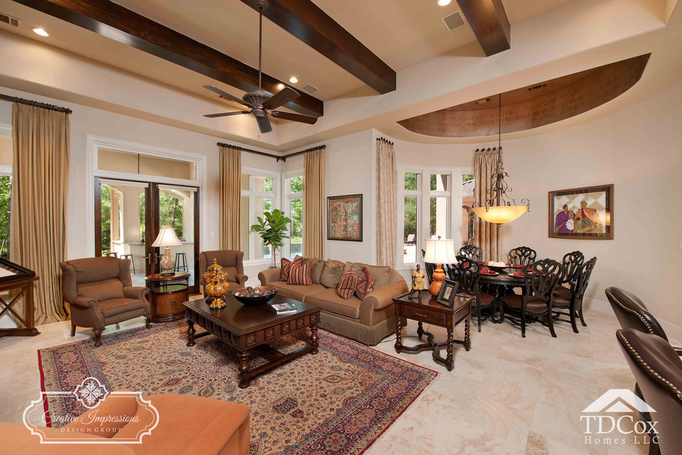 Photo of a large mediterranean open concept living room in Houston with beige walls, travertine floors and no tv.