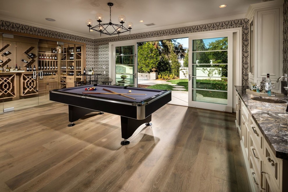 Photo of a traditional enclosed family room in Los Angeles with a game room, grey walls and medium hardwood floors.